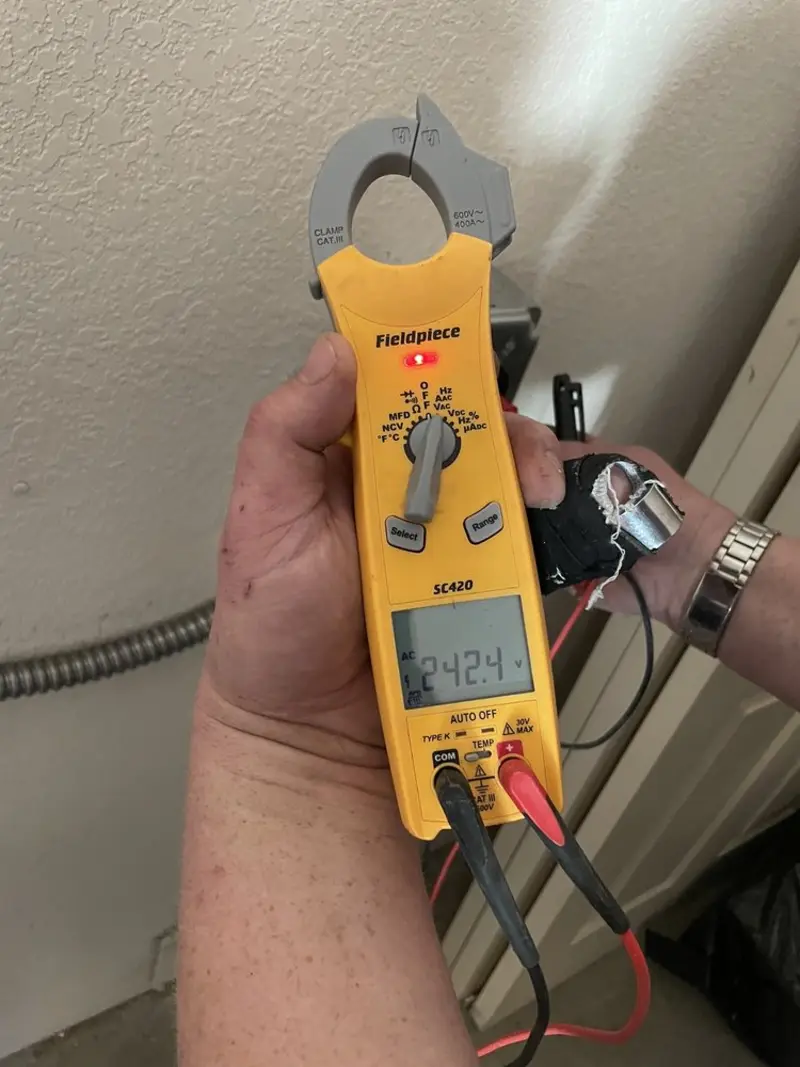 Voltage testing with clamp meter during Ceiling Fan Installation in Suffern